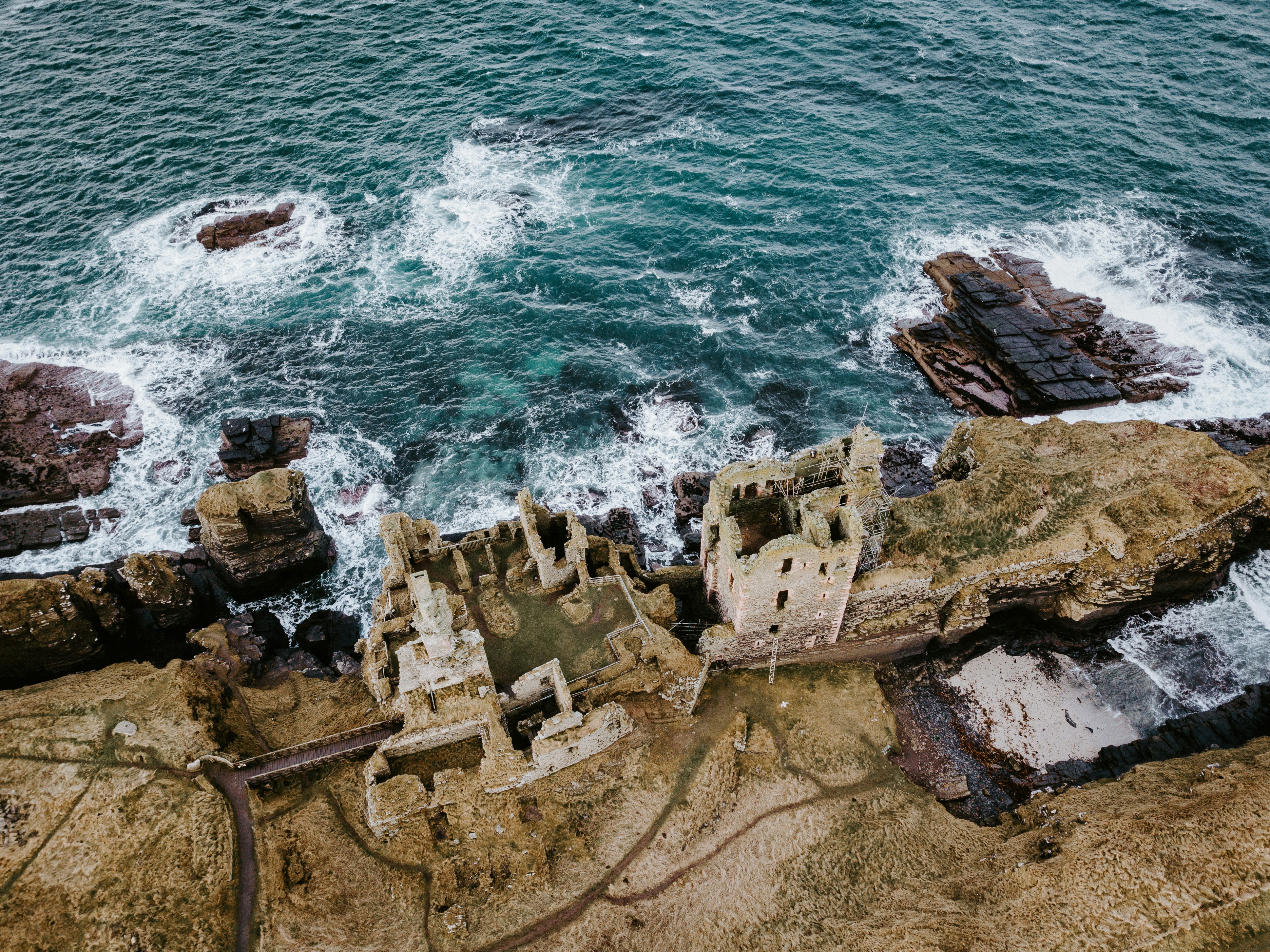 brown castle ruins across sea